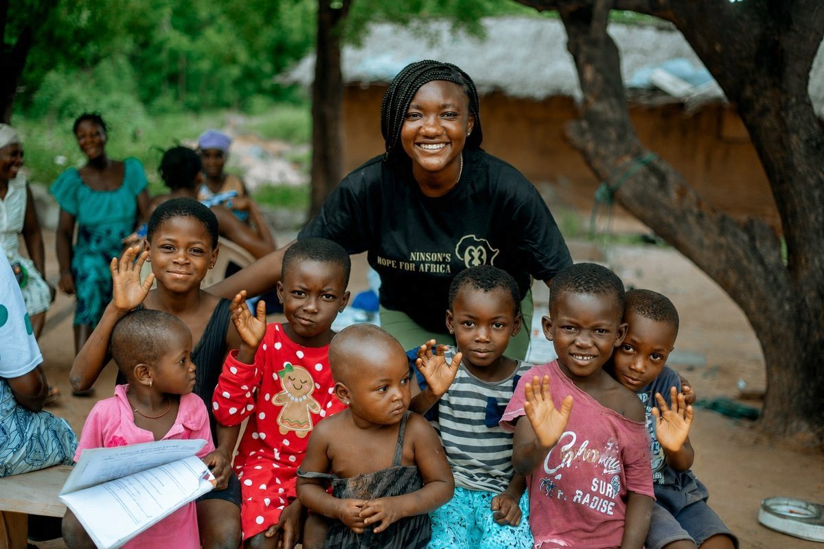 A volunteer with children in the community
